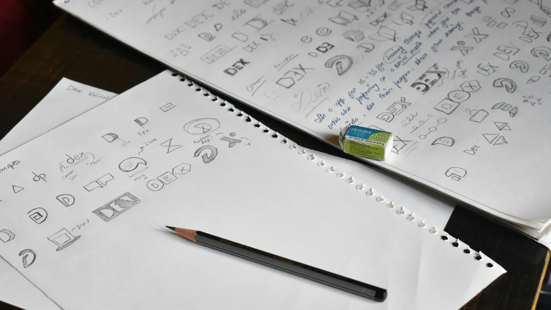 a pencil sitting on top of a pile of paper