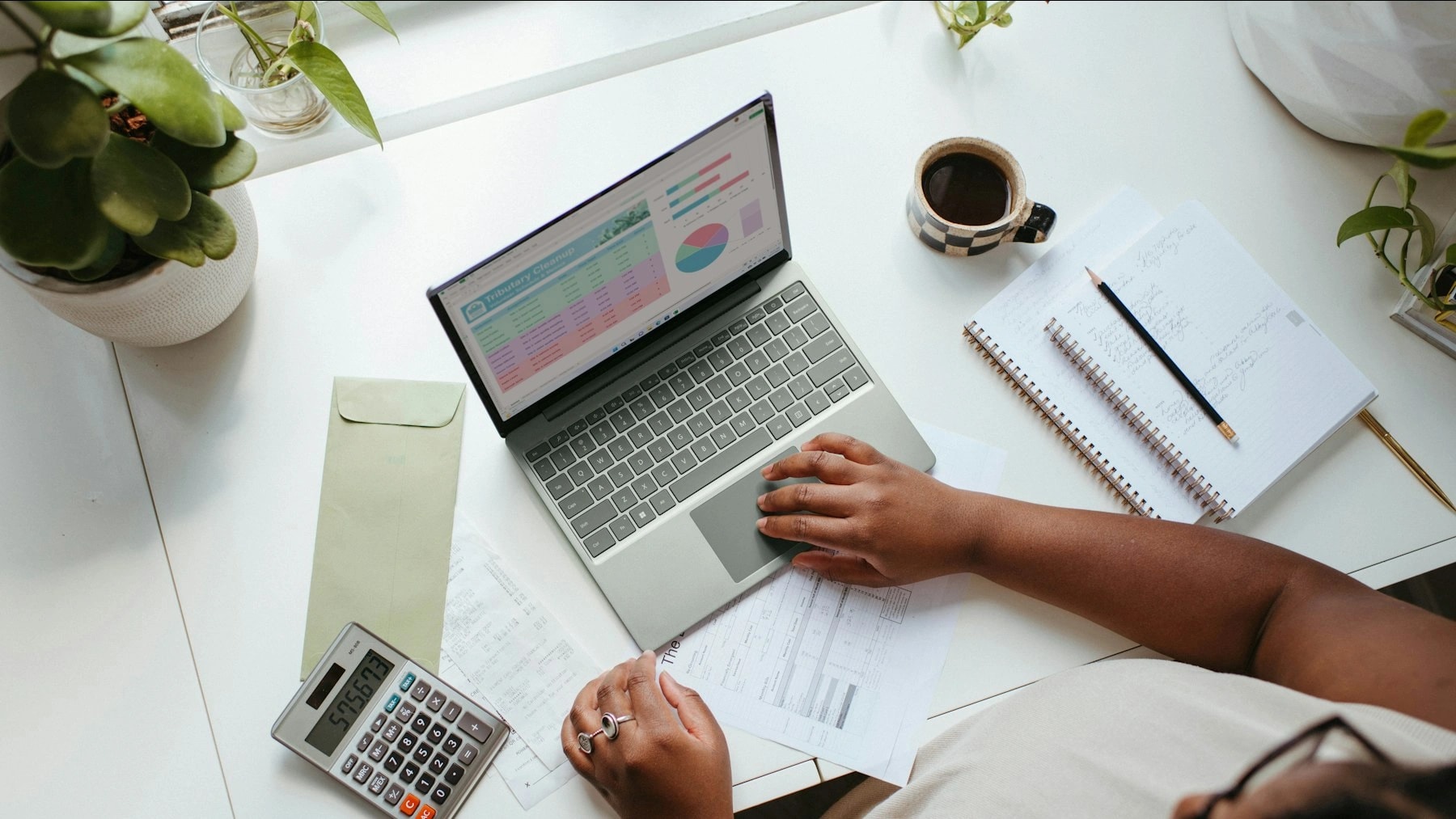 a person sitting at a table with a laptop